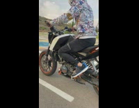 Guy does wheelie on motorcycle falls