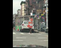 Lady wearing orange traffic cone runs crosswalk