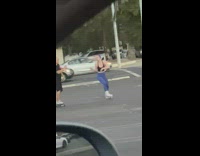 Woman headphones skate and sing parking lot