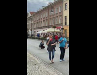 White shirt guy poses middle of street
