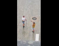 White shirt guy two walking sticks rain 