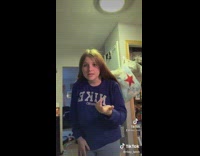 Girl holds three cats like guns 