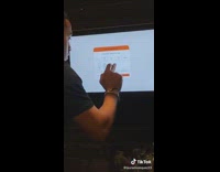 Man draws a stick drawing in the signature field on kiosk