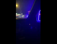 Van drives with blue lights at night