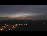 Guy flies drone over city night time 