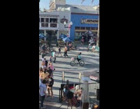 Guy blue shirt ride bike guitar case