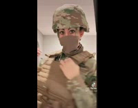 Lady wearing military uniform changes into regular clothes 