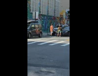 Green shirt guy leans on black car 