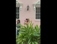 Two girls dress stand beside pink wall