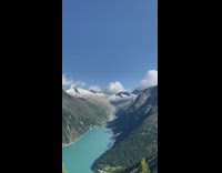 Scenery view of a valley with a lake between two mountain ranges 
