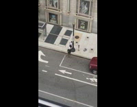 Woman white crop top lean on lamppost sidewalk