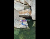Group of people dressed as mermaids laying on rocks and swimming  