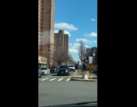 Man in spiderman costume waving at people 