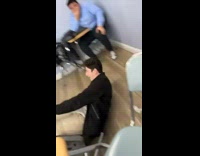 Guy kicks chair makes friend fall back