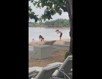 Woman green onesie bend over pose beach