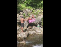 Girl black bikini sit rock striped blanket