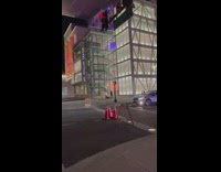 Woman in violet dress sits on the ground