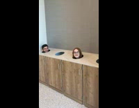 Two people head emerges from trash hole