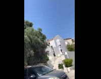 Man shirtless poses on top of the barrier