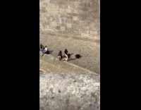 Three women poses with wine at canal