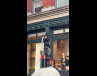 Man with mask stands at digital signage