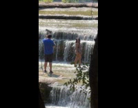Woman bikini flexes butt small waterfalls shoot
