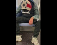 Passenger with american flag scarf uses vr headset on subway train