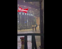 Two girls lay on ground while raining