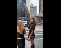 Man plays shofar stands at pedestrian curb
