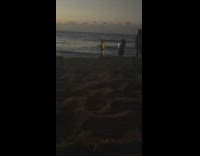 Girl black onesie beach night phone lights