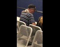 White gray rat crawls on mans shoulder in subway station