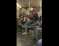 Red jacket guy sits blue scooter subway 
