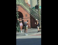 Woman black sports bra pose beside lamp pole