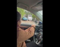 Driver has small side mirror squeegee