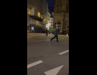 Woman black jacket walk across street night