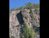 Guy jumps off high cliff into water and then says butt hurts