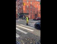 Man green dress dances middle of street
