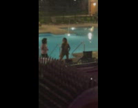 Two women tiktok dance lifts shirt poolside