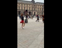 Two women different photoshoot outside The Louvre