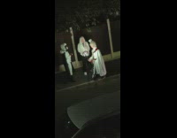 Three people in anime costume poses with a ring light