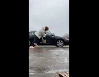 Guy slipping on ice holds onto door