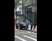 Man blue shirt dance hump cybertruck street