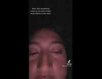 Girl shows kitten on her back watching her