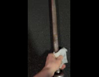 Man wipes off dirt from barbell rod