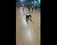 Guy lays back on roller skate rink 