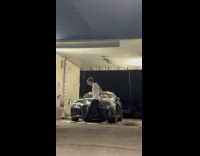 Woman does car wash trend and slides off car 