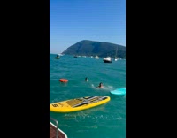 Two men run on surfboard on water