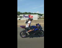 Guy rides motorcycle with tiny dog blue goggles 