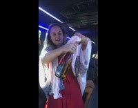 Woman pops champagne bottle but pours on head