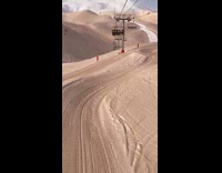 Guy rides ski lift over desert